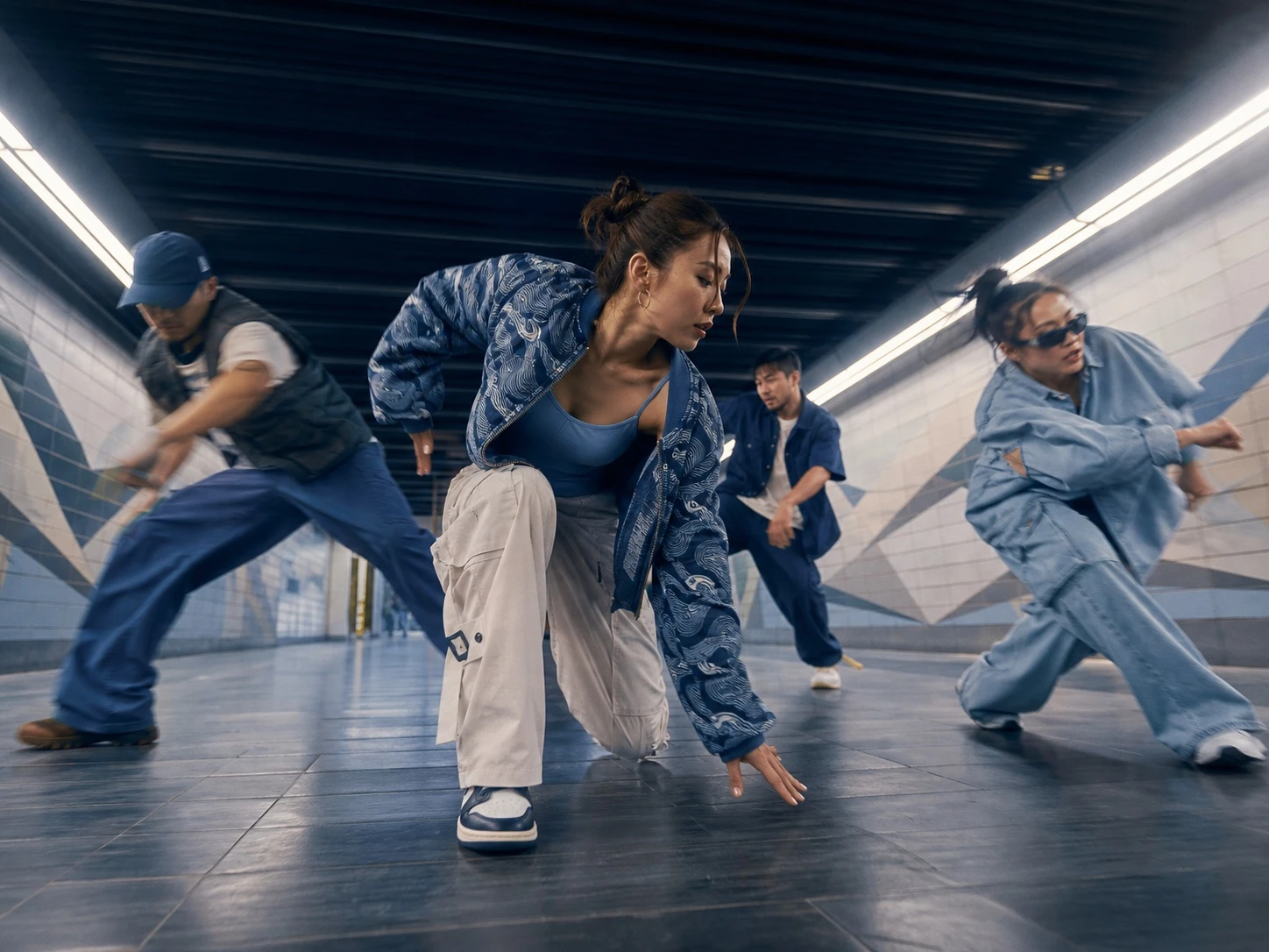 Vietnamese hip-hop dancers moving through a city tunnel